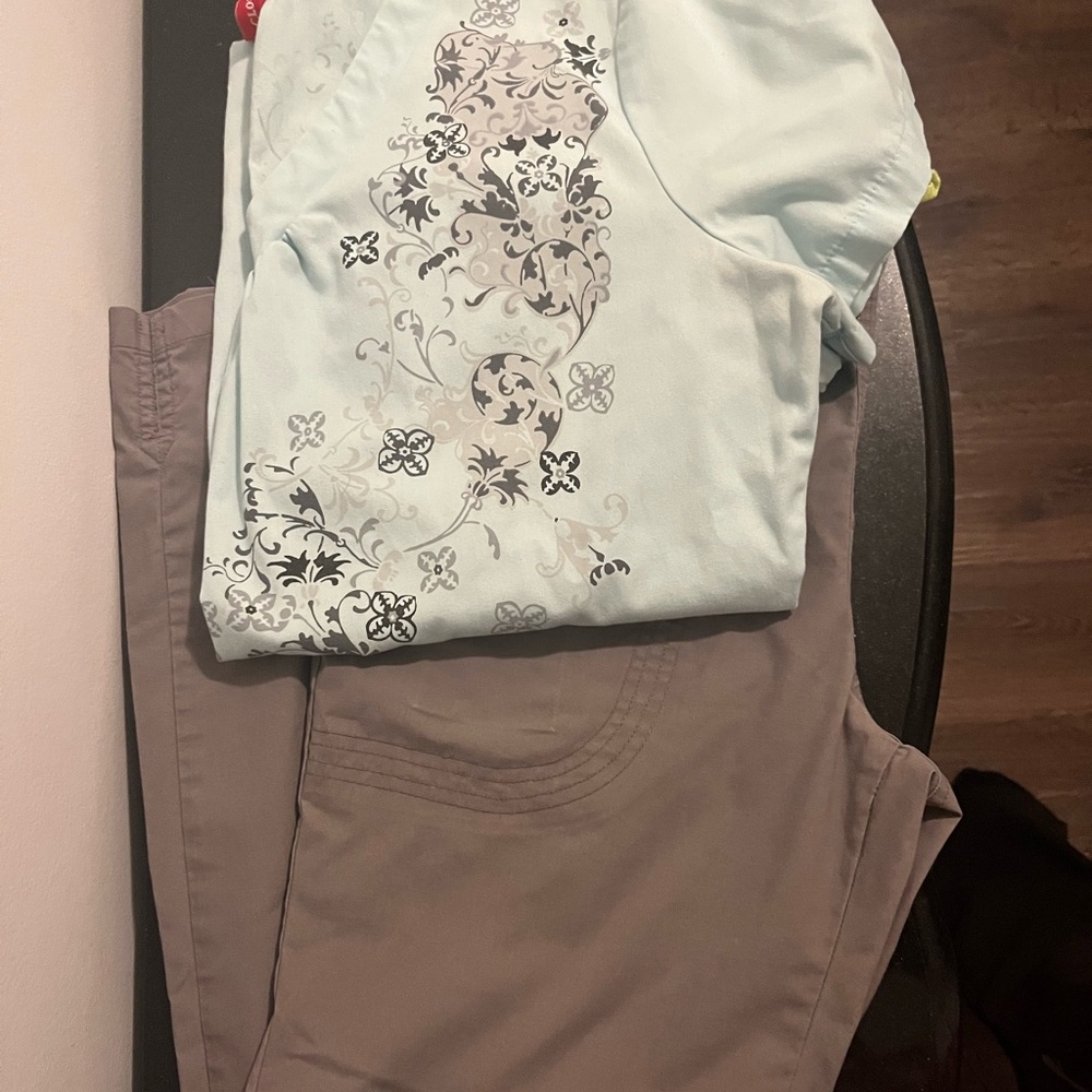 Floral print light blue scrub top and gray pants. Medical scrub set